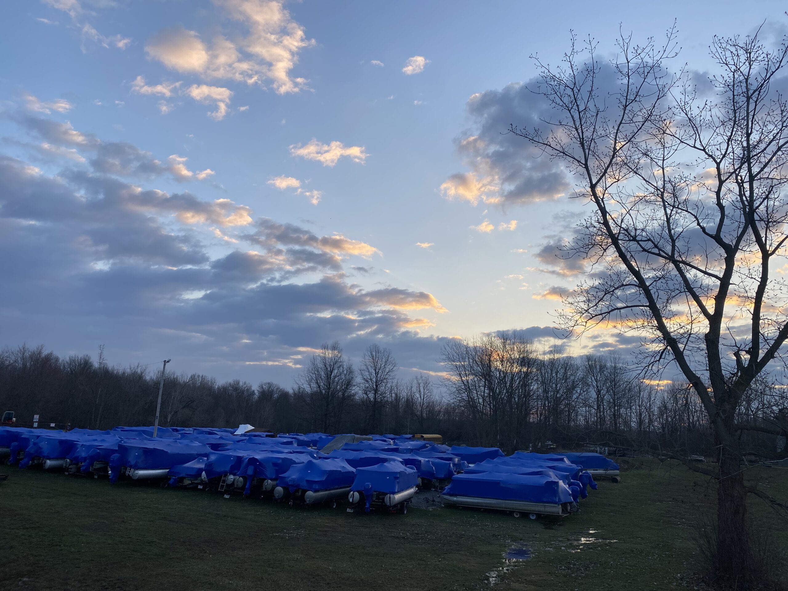 Boat Storage Blue tarps cover a variety of boats to protect them from damages